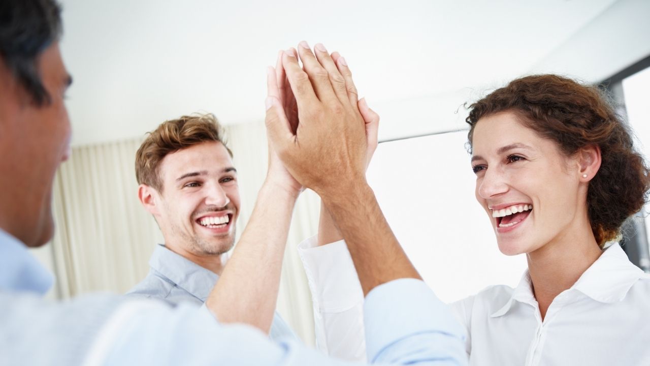 3 employees giving high fives
